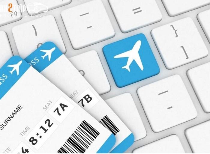 Person booking flights online using a laptop.